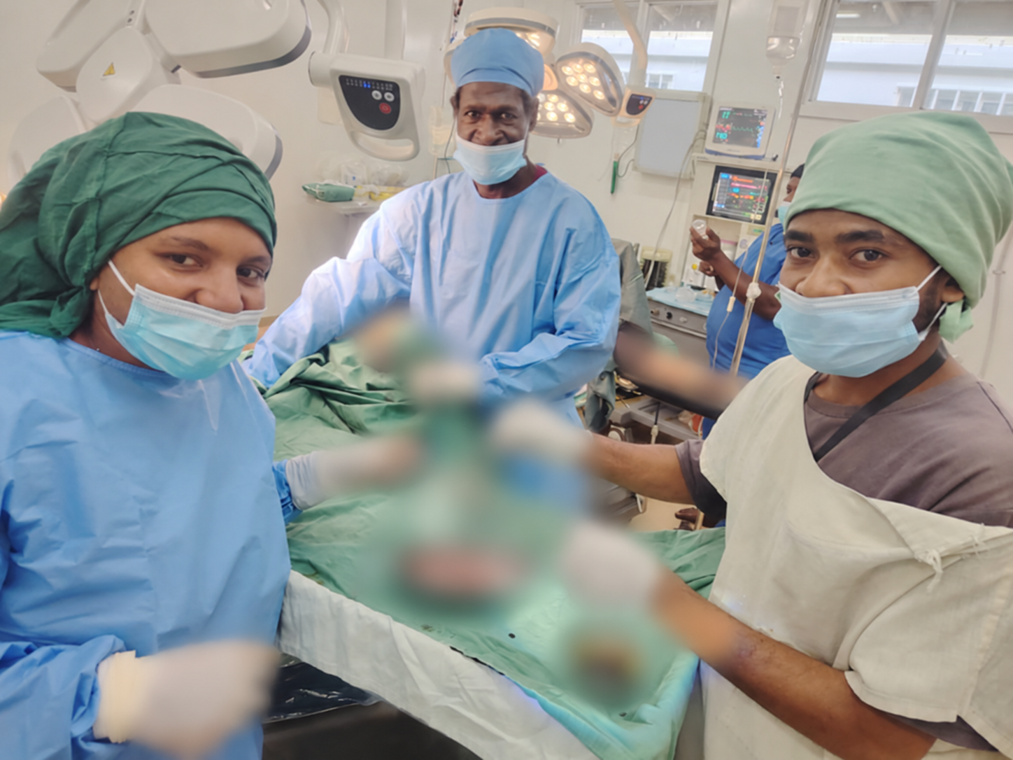 Students and hospital staff during theatre placement, with sensitive clinical details digitally blurred.